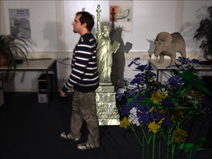 Final mixing result with shadow mapping. In this example two light sources are placed left and right of the camera. The real light sources have been simulated in the shadow mapping and shadow casting between virtual content and real dynamic content is visible. (Note the shadow on the legs of the person.)